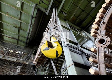 Crane hook in old abandoned coal mine, focus on the hook. Stock Photo