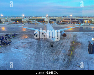 a large plane on an icy tarmac at JFK ariport Stock Photo