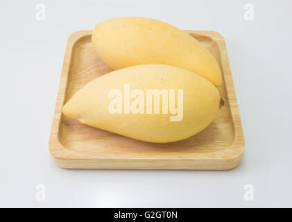 fresh delicious yellow mango in wood plate  isolated  on white background Stock Photo