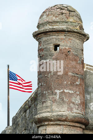US flag waving in the wind above the walls of the historic Castillo de San Marcos fort in St. Augustine, Florida, USA. Stock Photo