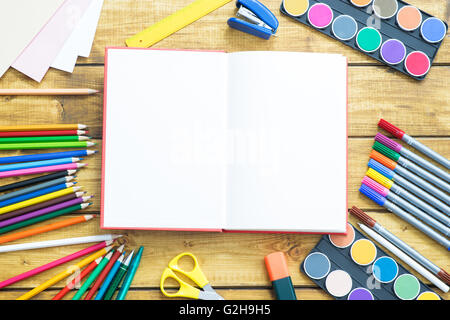 School items make a frame on wooden background Stock Photo