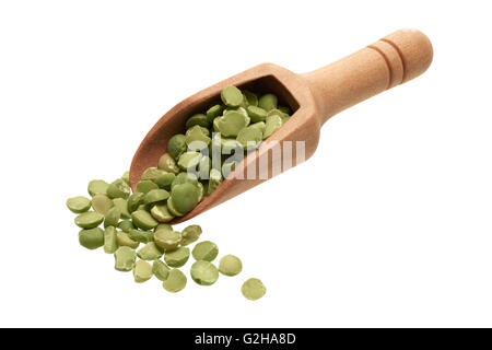 Food ingredients: heap of dried green peas in a wooden scoop, on white background Stock Photo