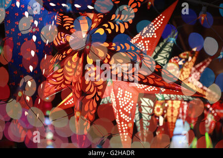 Star shaped lantern line through the colorful blur decoration lights during an Indian festival Stock Photo