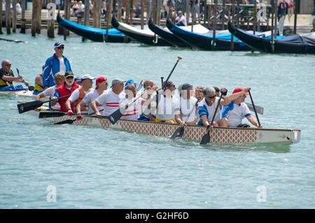 Rowers from many countries participate in the 42nd Vogalonga regatta on the Grand Canal near the the Basilica della Salute in Venice, Italy on Sunday, May 15, 2016. The Vogalonga, a non-competitive recreational sporting event for amateur athletes, is part of the annual “Venice International Dragon Boat Festival.' The Grand Canal is closed to motor-driven boats during the event. Credit: Ron Sachs/CNP - NO WIRE SERVICE - Stock Photo