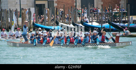 Rowers from many countries participate in the 42nd Vogalonga regatta on the Grand Canal near the the Basilica della Salute in Venice, Italy on Sunday, May 15, 2016. The Vogalonga, a non-competitive recreational sporting event for amateur athletes, is part of the annual ·Venice International Dragon Boat Festival.' The Grand Canal is closed to motor-driven boats during the event. Credit: Ron Sachs/CNP - NO WIRE SERVICE - Stock Photo