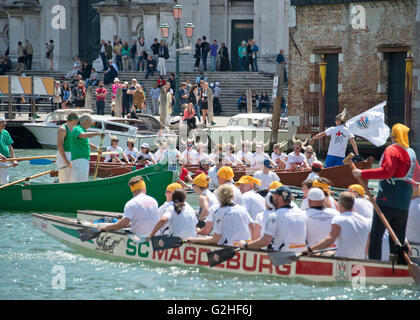 Rowers from many countries participate in the 42nd Vogalonga regatta on the Grand Canal near the the Basilica della Salute in Venice, Italy on Sunday, May 15, 2016. The Vogalonga, a non-competitive recreational sporting event for amateur athletes, is part of the annual ·Venice International Dragon Boat Festival.' The Grand Canal is closed to motor-driven boats during the event. Credit: Ron Sachs/CNP - NO WIRE SERVICE - Stock Photo