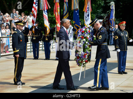 United States President Barack Obama (C) is assisted as he lays a wreath at the Tomb of the Unknown Soldier at Arlington National Cemetery, Arlington, Virginia, on Memorial Day, May 30, 2016, near Washington, DC. Obama paid tribute to the nation's military service members who have fallen. Credit: Mike Theiler / Pool via CNP Stock Photo