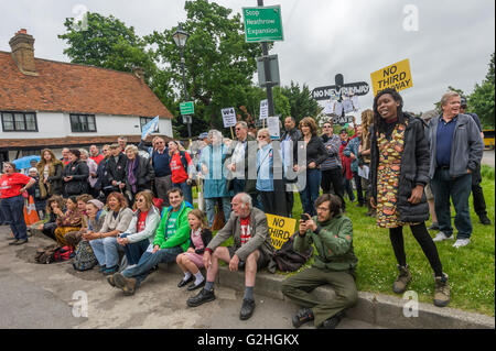 Harmondsworth, London, UK. 30th May, 2016 HACAN and  anti-3rd runway campaigners in Harmondsworth 'celebrate' Heathrow’s 70th Birthday with 70 ‘No 3rd Runway’ balloons and over 750 black airplanes on the village green, representing the number of homes that would be destroyed. People listen to speeches at the start of the event. Credit:  Peter Marshall/Alamy Live News Stock Photo