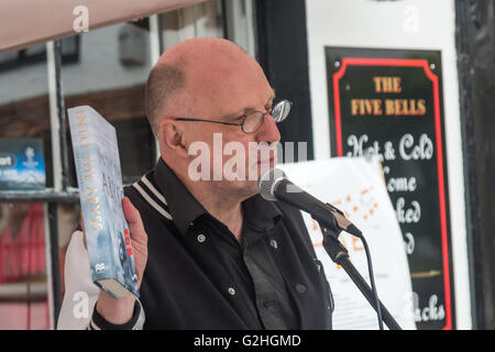Harmondsworth, London, UK. 30th May, 2016 John Stewart of HACAN holds up one of the many 'gifts' for Heathrow on its 70th Birthday from anti-3rd runway campaigners, aq copy of the book 'Into the Abyss'. s. Credit:  Peter Marshall/Alamy Live News Stock Photo