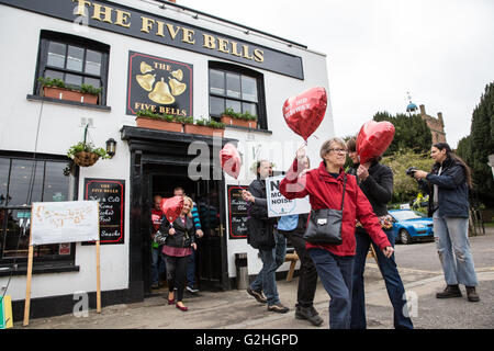 Harmondsworth, UK. 30th May, 2016. Campaigners against Heathrow expansion, including UKIP London Assembly member David Kurten, bring seventy 'No 3rd Runway' balloons out of the Five Bells pub to mark Heathrow’s 70th birthday in Harmondsworth village. Much of Harmondsworth would be flattened should plans for a 3rd runway be approved. Credit:  Mark Kerrison/Alamy Live News Stock Photo