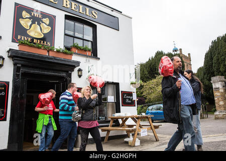 Harmondsworth, UK. 30th May, 2016. Campaigners against Heathrow expansion, including UKIP London Assembly member David Kurten, bring seventy 'No 3rd Runway' balloons out of the Five Bells pub to mark Heathrow’s 70th birthday in Harmondsworth village. Much of Harmondsworth would be flattened should plans for a 3rd runway be approved. Credit:  Mark Kerrison/Alamy Live News Stock Photo