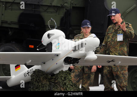 Schoenefeld, Germany. 01st June, 2016. Two German Bundeswehr soldiers look at a Luna recon drone at the Berlin Air Show (ILA) in Schoenefeld, Germany, 01 June 2016. The air show at Berlin-Schoenefeld Airport is open from 01 to 04 June 2016. Photo: WOLFGANG KUMM/dpa/Alamy Live News Stock Photo