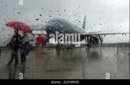 Schoenefeld, Germany. 01st June, 2016. Visitors to the fair walk across the site in the rain at the Berlin Air Show (ILA) in Schoenefeld, Germany, 01 June 2016. The air show at Berlin-Schoenefeld Airport is open from 01 to 04 June 2016. Photo: WOLFGANG KUMM/dpa/Alamy Live News Stock Photo