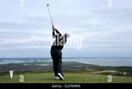 Isle of Purbeck Golf Club, Dorset, UK, 31st May, 2016. Sam Robertshawe (The Army GC) drives from the 5th hole during the second round of the Jamega Pro Golf Tour at the Isle of Purbeck Golf Club, England with the Bournemouth coastline in the background. Credit:  David Partridge / Alamy Live News Stock Photo
