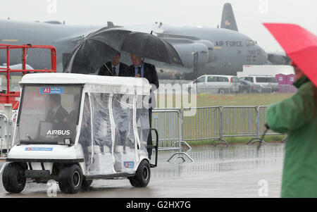 Schoenefeld, Germany. 01st June, 2016. Visitors to the fair are driven across the fairgrounds in heavy rainfall at the Berlin Air Show (ILA) in Schoenefeld, Germany, 01 June 2016. The air show at Berlin-Schoenefeld Airport is open from 01 to 04 June 2016. Photo: WOLFGANG KUMM/dpa/Alamy Live News Stock Photo
