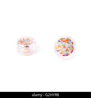Beads in round box over white isolated background Stock Photo