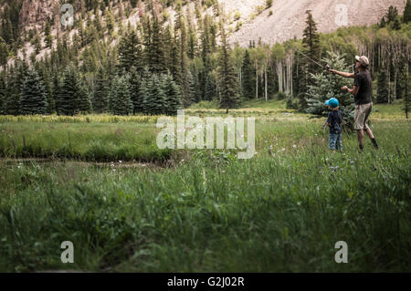 Dad and Young Son Fly Fishing Stock Photo