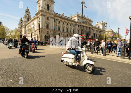 Mods riding their scooters through Parliament Square for the London to Brighton Scooter Rally in May 1st 2016 Stock Photo