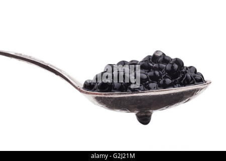 Black caviar beads on silver spoon close-up isolated on white background Stock Photo