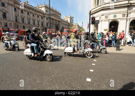 Mods riding their scooters through Parliament Square for the London to Brighton Scooter Rally in May 1st 2016 Stock Photo