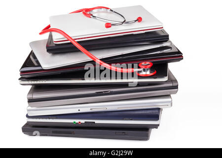 Huge laptop pile with a red stethoscope isolated on white Stock Photo