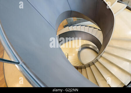 Modern spiral staircase in London at the Wellcome Collection museum at 183 Euston Rd, Kings Cross, London NW1 2BE Stock Photo