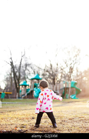 Young Child Wearing Heart Pattern Fleece Jacket on Field Near Playground, Stratford, Connecticut, USA Stock Photo