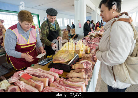 https://l450v.alamy.com/450v/g2j4y2/a-woman-buys-meat-at-the-counter-of-a-local-butcher-at-a-local-farmers-g2j4y2.jpg