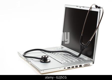 silver laptop diagnosis with black stethoscope  isolated on white background Stock Photo