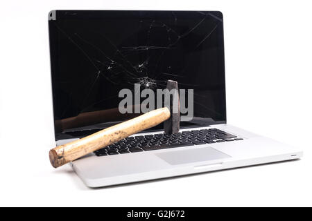 Broken laptop with smashed screen and a hammer isolated on white background Stock Photo