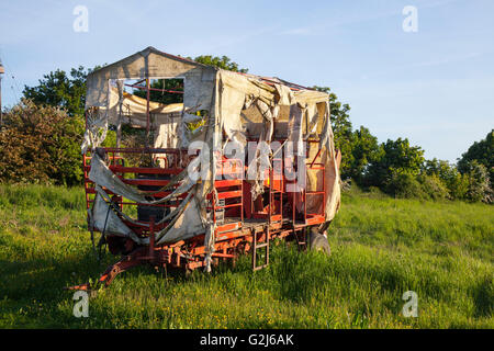 Disused GRIMME farm potato harvesting trailer illuminated in low light, in Burscough, Lancashire, UK Stock Photo