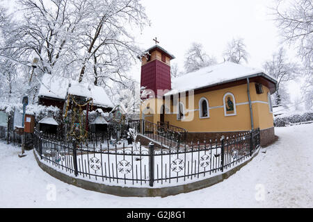 a small ortodox church covered with snow in the winter Stock Photo