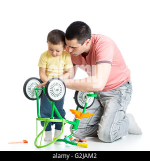 Child boy and daddy fixing bisycle Stock Photo