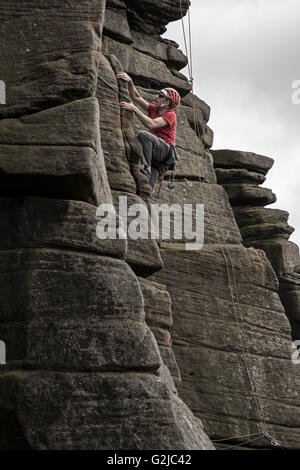 Stanage Top Rope Climber on the cliffs of Stanage Plantation in the Peak District of ...