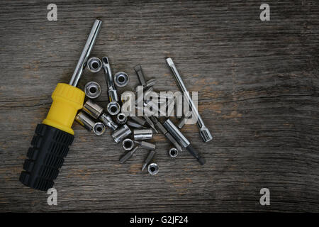 Screwdriver with allen and bits on wood surface Stock Photo