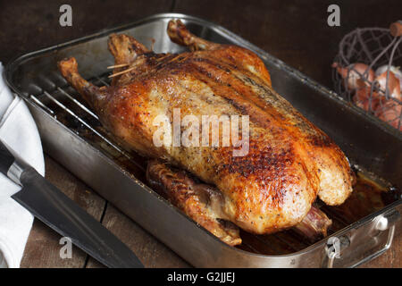 Crispy roasted Barbery Duck in in roasting pan ready for serving Stock Photo