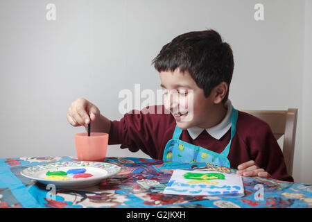 Art class in primary school-schoolboy paint a picture Stock Photo
