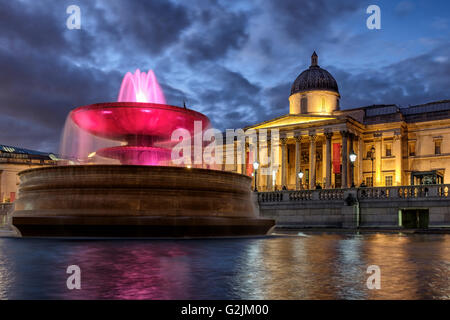 Floodlit Fountain and The National Galleryat night,Trafalgar Square,London,England Stock Photo