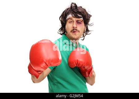 Young boxer with a black eye and red boxing gloves isolated on white background Stock Photo