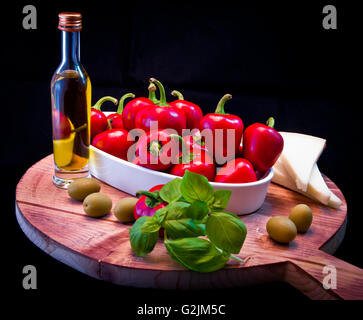 Ingredients for a Mediterranean sauce for pasta, bruschetta, salad or sandwich with olive oil, peppers, basil, cheese, figs and Stock Photo