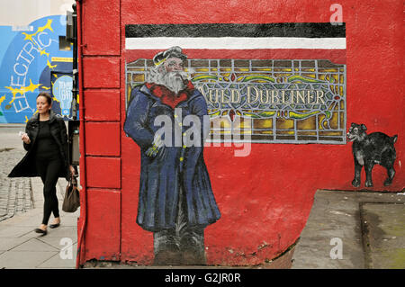 A woman walk on the sidewalk next the Auld Dubliner pub in Dublin, Temple Bar area, Ireland Stock Photo