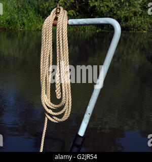 Mooring rope on hung on Tiller of Narrowboat Staffordshire and Worcester canal in late summer Cannock Chase Area of Outstanding Stock Photo