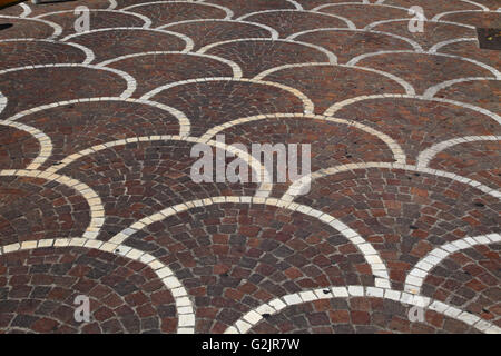 Blocks curved pavements arched Morocco style ancient Moorish across Mediterranean common interlocked design brown and white. Stock Photo