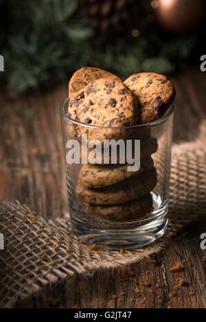 Fresh baked chocolate chip cookies in a glass on a rustic wooden table. Stock Photo