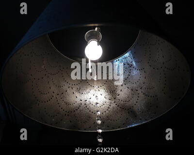 Light bulb shines in lamp Stock Photo