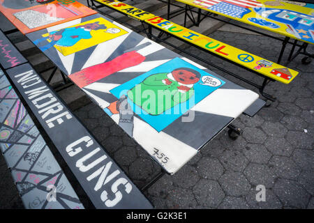 School lunchroom tables decorated with art representing various social issues are seen in Union Square Park in New York on Tuesday, May 24, 2016. The tables are a project by LeAp's public art program where young people worked with artists to create works that reflect current issues that effect them. Learning through an Expanded Arts Program (LeAp) displayed the tables as part of the kick-off for the campaign. Starting in June and through August the ten tables will be placed in ten different parks throughout the city. (© Richard B. Levine) Stock Photo