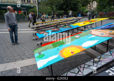 School lunchroom tables decorated with art representing various social issues are seen in Union Square Park in New York on Tuesday, May 24, 2016. The tables are a project by LeAp's public art program where young people worked with artists to create works that reflect current issues that effect them. Learning through an Expanded Arts Program (LeAp) displayed the tables as part of the kick-off for the campaign. Starting in June and through August the ten tables will be placed in ten different parks throughout the city. (© Richard B. Levine) Stock Photo