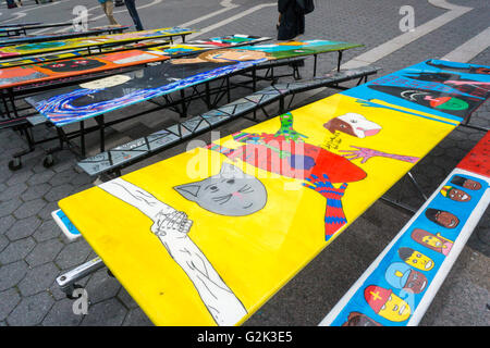 School lunchroom tables decorated with art representing various social issues are seen in Union Square Park in New York on Tuesday, May 24, 2016. The tables are a project by LeAp's public art program where young people worked with artists to create works that reflect current issues that effect them. Learning through an Expanded Arts Program (LeAp) displayed the tables as part of the kick-off for the campaign. Starting in June and through August the ten tables will be placed in ten different parks throughout the city. (© Richard B. Levine) Stock Photo