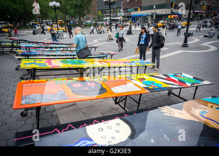 School lunchroom tables decorated with art representing various social issues are seen in Union Square Park in New York on Tuesday, May 24, 2016. The tables are a project by LeAp's public art program where young people worked with artists to create works that reflect current issues that effect them. Learning through an Expanded Arts Program (LeAp) displayed the tables as part of the kick-off for the campaign. Starting in June and through August the ten tables will be placed in ten different parks throughout the city. (© Richard B. Levine) Stock Photo