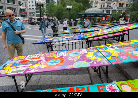 School lunchroom tables decorated with art representing various social issues are seen in Union Square Park in New York on Tuesday, May 24, 2016. The tables are a project by LeAp's public art program where young people worked with artists to create works that reflect current issues that effect them. Learning through an Expanded Arts Program (LeAp) displayed the tables as part of the kick-off for the campaign. Starting in June and through August the ten tables will be placed in ten different parks throughout the city. (© Richard B. Levine) Stock Photo